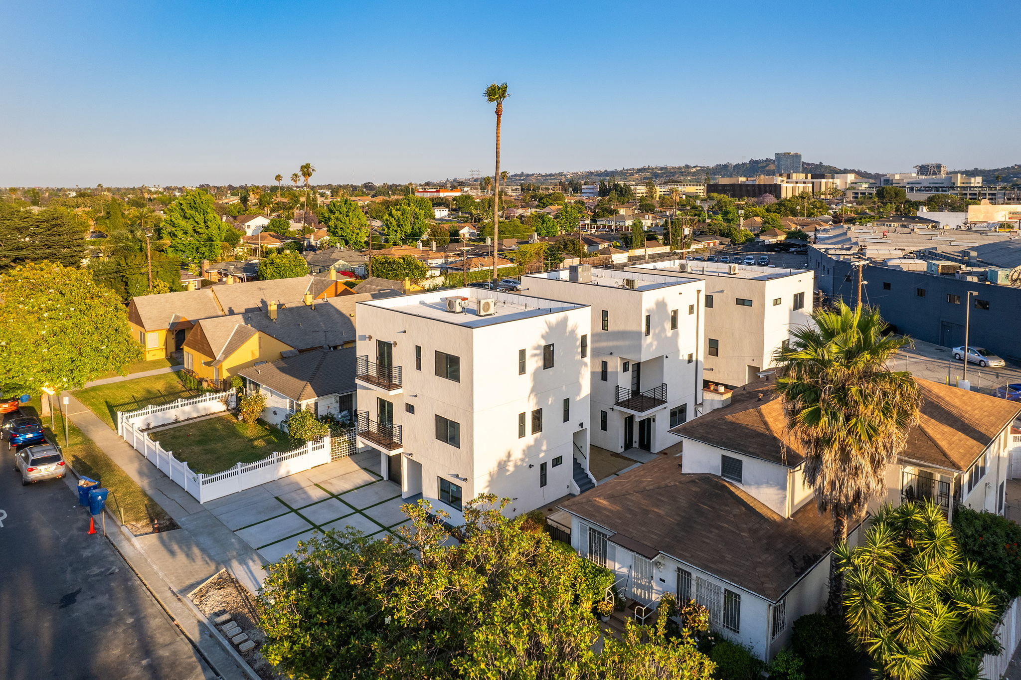 Aerial view of multifamily residential complex surrounded by neighborhood homes.