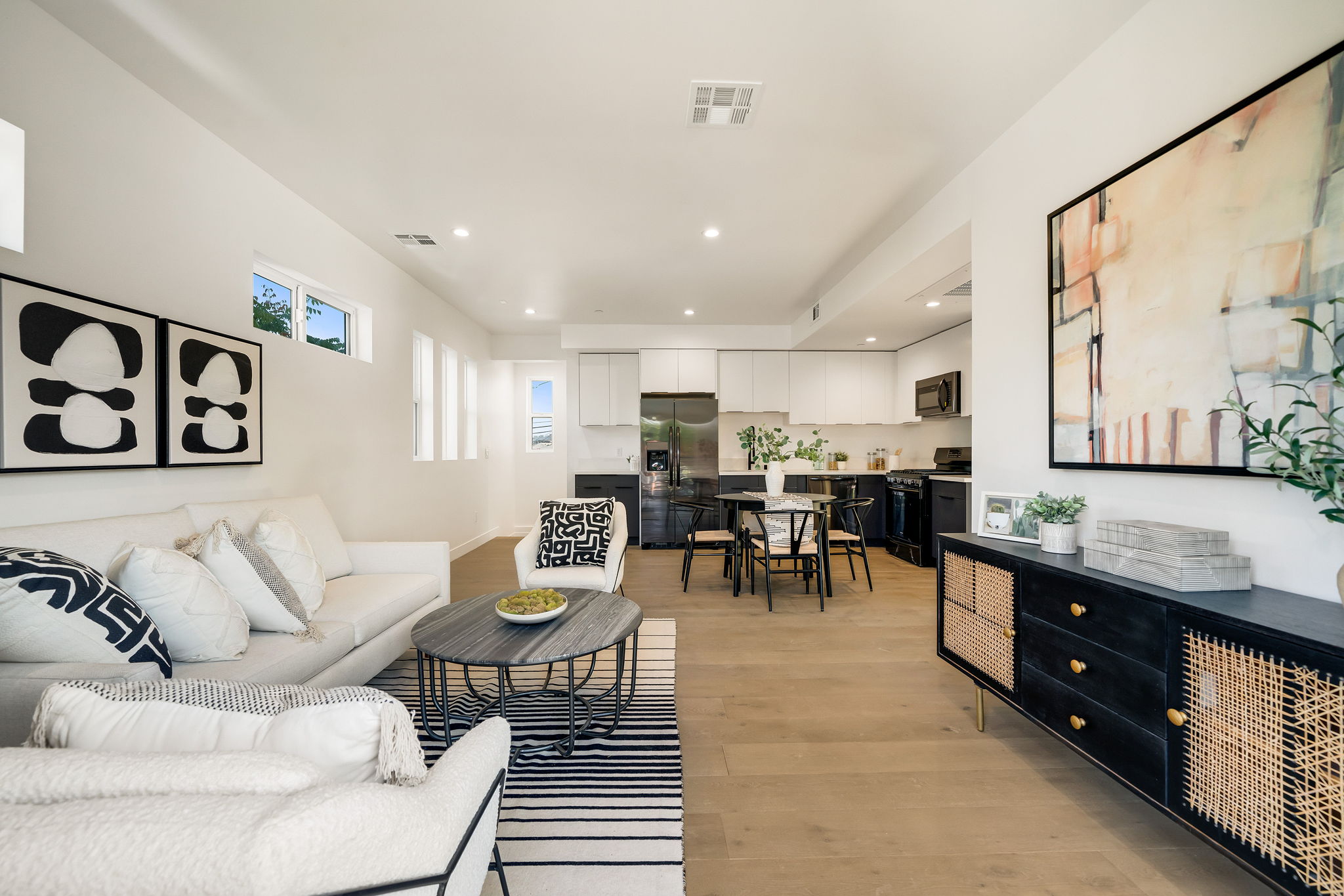Open-concept living room and dining area with neutral decor and modern finishes.