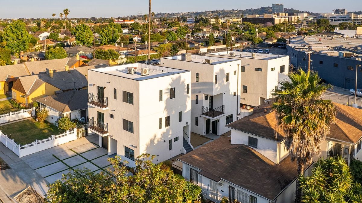 Contemporary multifamily residential building with rooftop terrace and modern apartment design