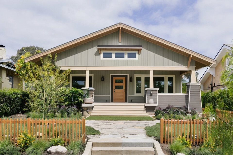 Craftsman-style single-family home with front porch and landscaped walkway.