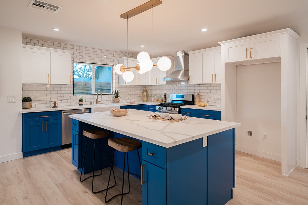 Modern custom kitchen remodel with blue cabinetry, white countertops, and open layout in Pasadena home