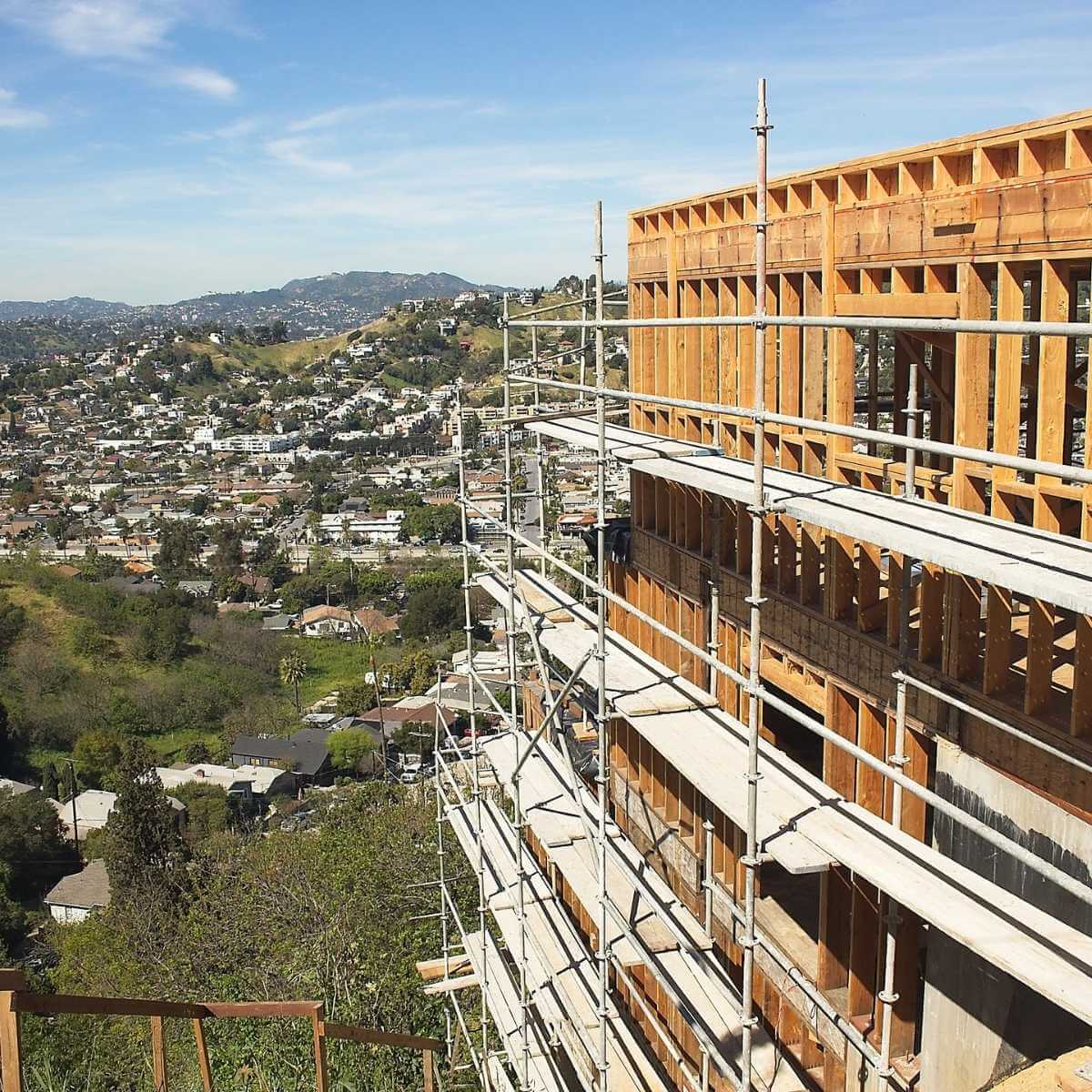 Hillside home construction in Pasadena with structural framing and valley views.