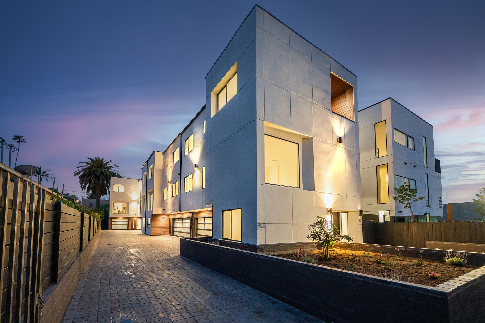 Modern multifamily apartment building with geometric design and large windows.