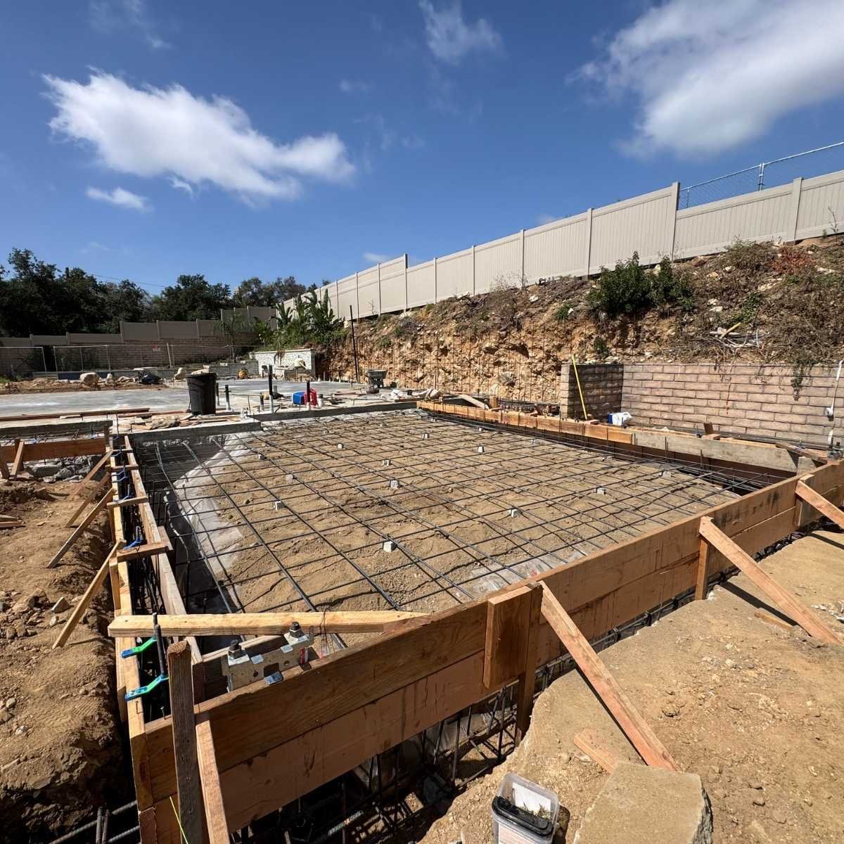 ATP Development & Construction caisson rebar reinforcement and foundation footing installation along an excavated hillside, showcasing structural engineering and deep foundation work in the Los Angeles area